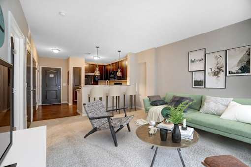 a living room with a couch and a tableat Taylor House Apartments, Columbus, OH, 43214