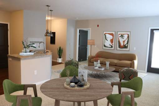 a living room and kitchen with a table and chairs
