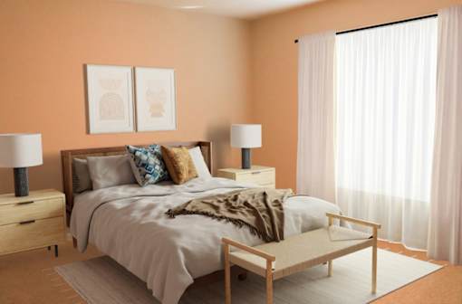 a bedroom with orange walls and white curtains and a bed with pillows