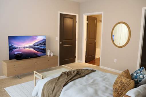 a bedroom with a bed and a tv in it