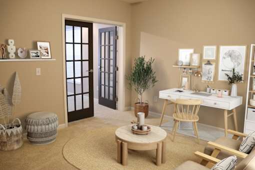 a living room with a desk and a chair