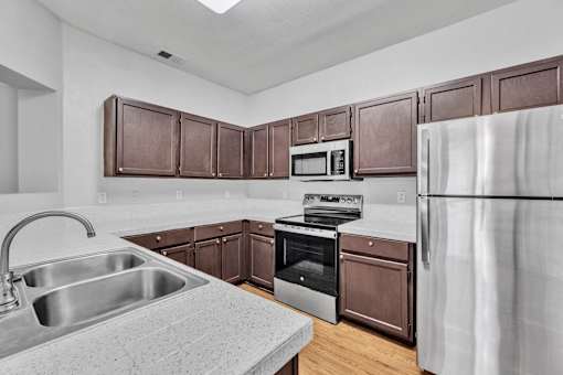 kitchen with wooden cabinets at Villas at Sonterra, San Antonio, TX 78258