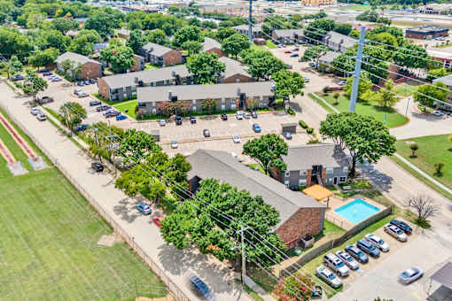 an aerial view of a neighborhood with houses and a parking lot