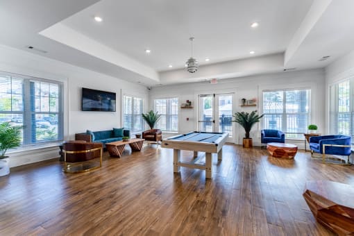 an open living room with a pool table and couches