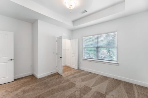 a living room with a large window and a door