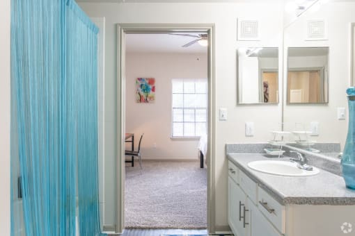 a bathroom with a blue shower curtain