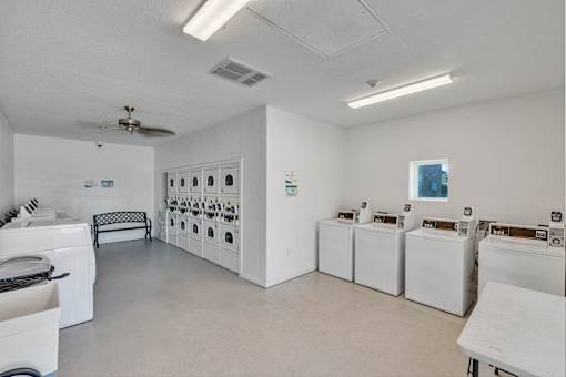 A laundry room with washers and dryers.
