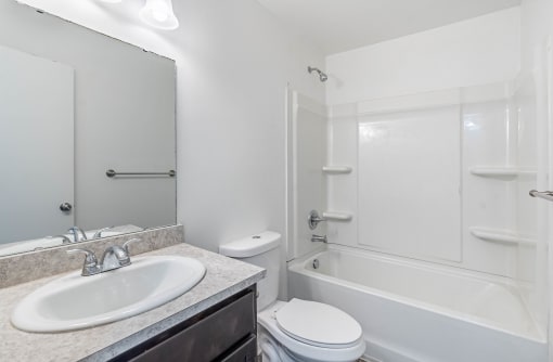 a bathroom with a sink toilet and a bath tub