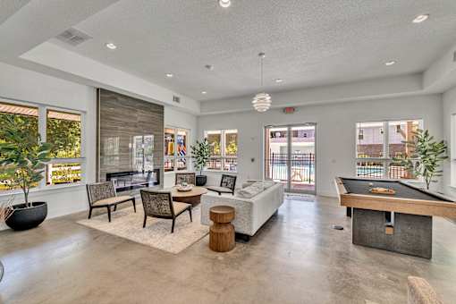 A spacious living room with a pool table and comfortable seating.