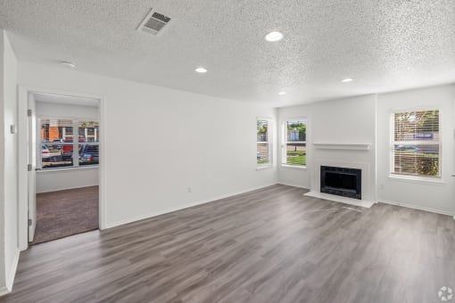 the living room and dining room of a new home with a fireplace