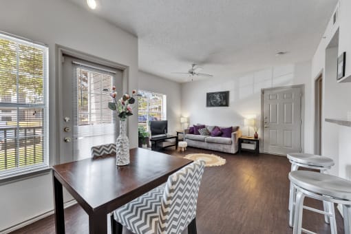 an open living room and dining room with a table and chairs