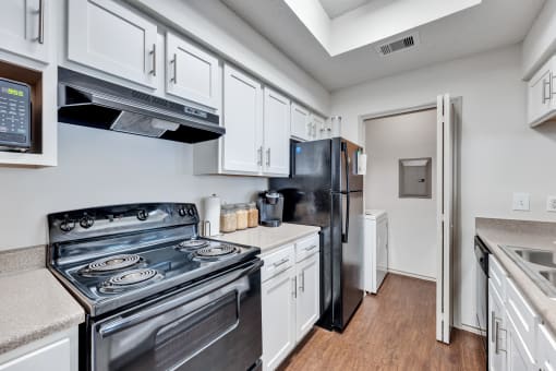 a kitchen with stainless steel appliances and white cabinets