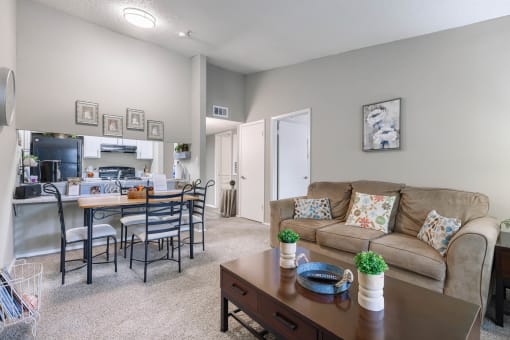 an open living room and kitchen with a couch and a table