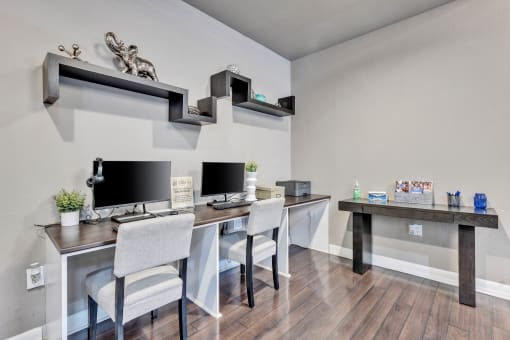 a home office with two desks and two computer monitors at Waters at Elm Creek, San Antonio, TX 78230