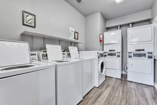 A row of washing machines in a laundromat at Waters at Elm Creek, Texas 78230