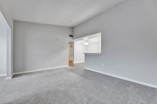 a spacious living room with gray carpet and white walls at Waters at Elm Creek, San Antonio, 78230