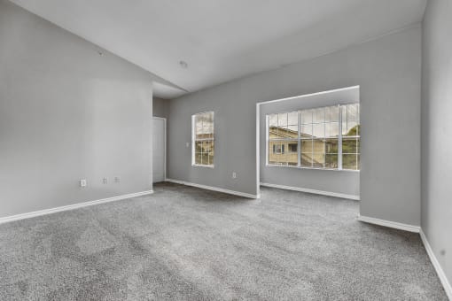the living room of a new home with carpet and a large window at Waters at Elm Creek, San Antonio, 78230