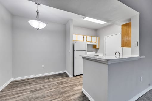 an empty kitchen with a counter top and a refrigerator at Waters at Elm Creek, Texas 78230