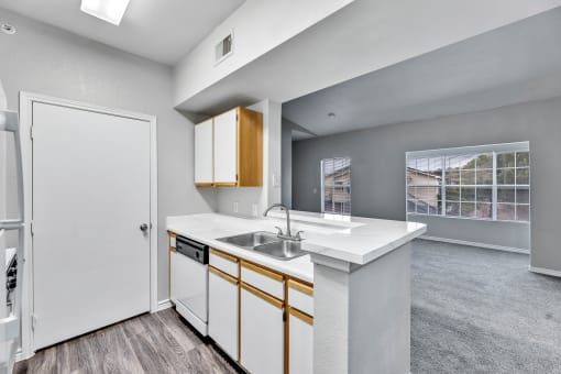 a kitchen with white cabinets and a sink and a refrigerator at Waters at Elm Creek, San Antonio, TX