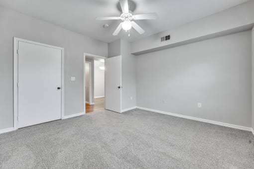 A room with a ceiling fan and carpeted floor at Waters at Elm Creek, San Antonio, 78230