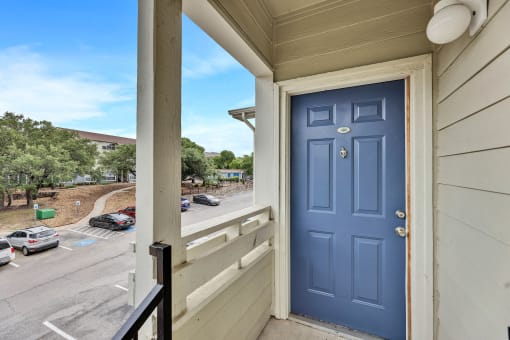 the view from the front door of a condo with a blue door at Waters at Elm Creek, San Antonio