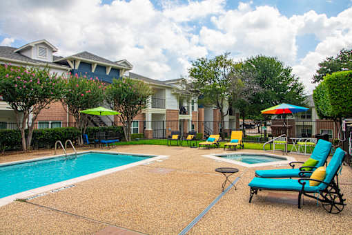 A pool area with a blue pool and a yellow chair.