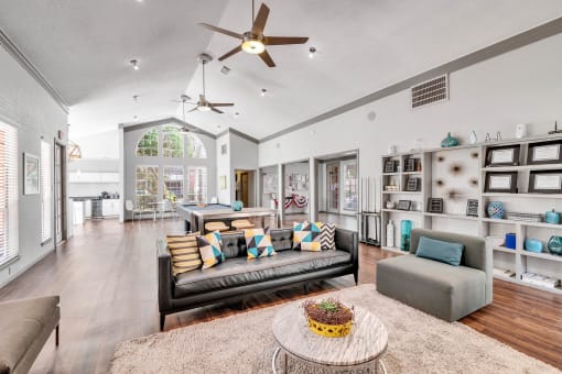 a living room with furniture and a ceiling fan