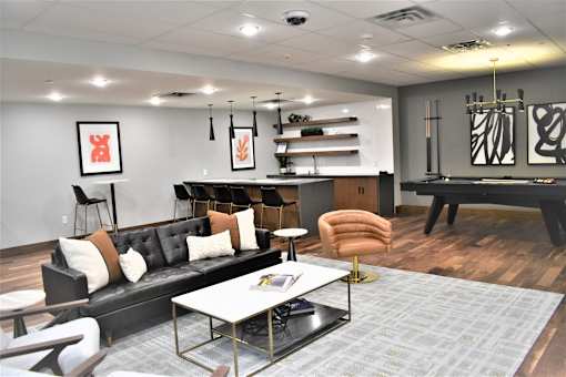 A modern living room with a black couch and a coffee table.