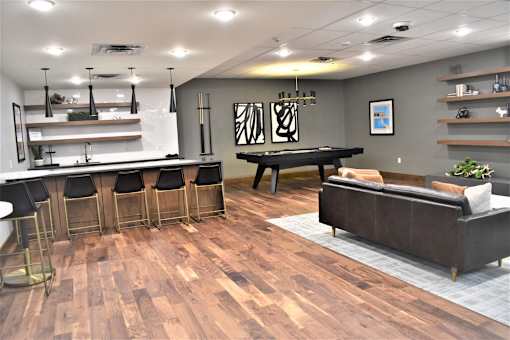 A room with a pool table and a couch.