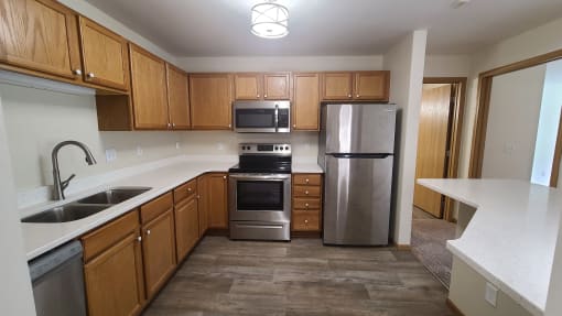 a kitchen with stainless steel appliances and wooden cabinets