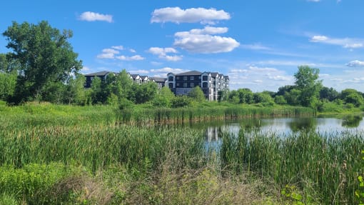 a building with a crane in front of a body of water