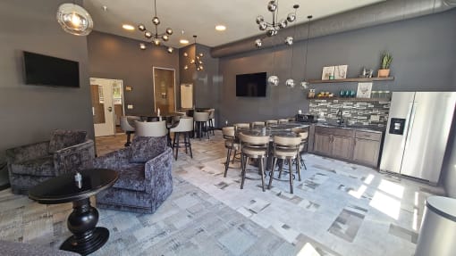 a dining room with tables and chairs and a kitchen