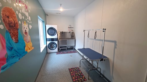 a laundry room with a washing machine and a blue table