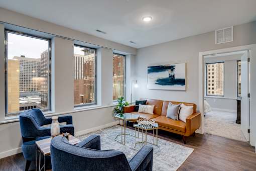 A living room with a couch, chairs, and a coffee table.
