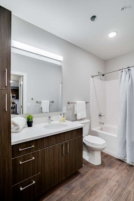 A modern bathroom with a white toilet and a white sink.