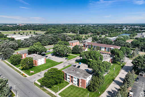 A bird's eye view of a campus with a red building in the center.