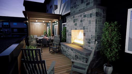 A couple is sitting in a backyard with a fireplace.