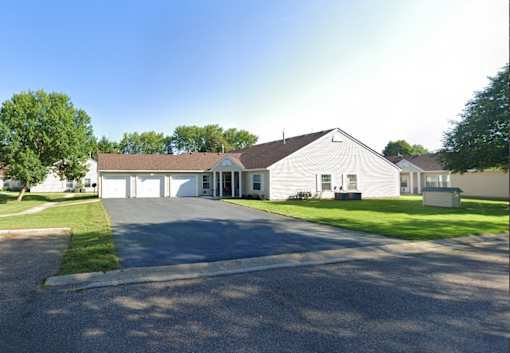 a white house with a driveway and a garage door