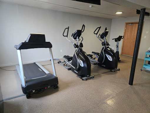 A room with exercise equipment and a treadmill.