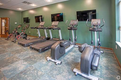 A gym with treadmills and exercise bikes.