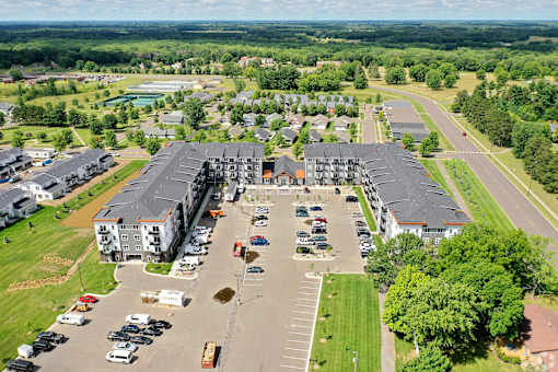 A parking lot in front of a large building.