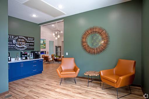 A room with a green wall and a framed circular object on the wall.