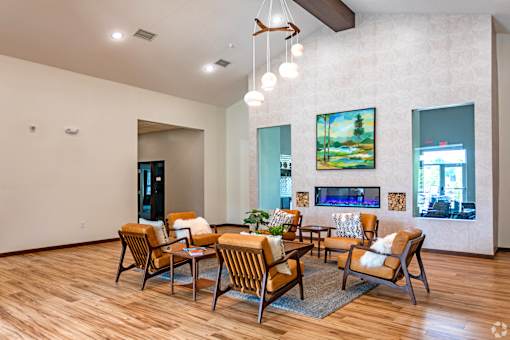 A modern living room with a wooden floor and a fireplace.
