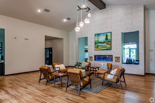 A living room with a fireplace and a painting on the wall.