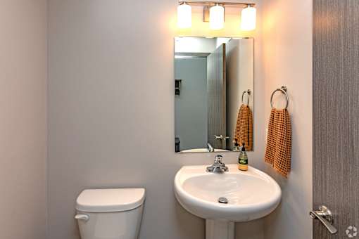A bathroom with a white toilet and a white sink.