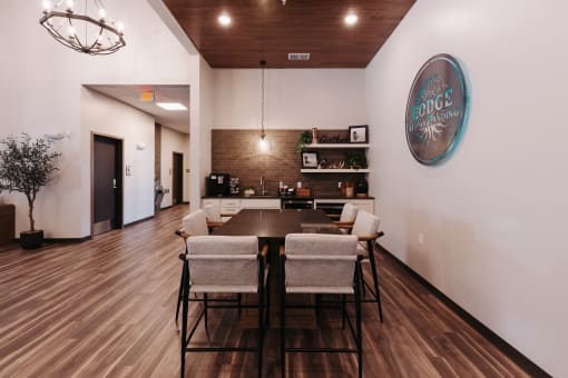 a dining room with a table and chairs and a wall with a sign on it
