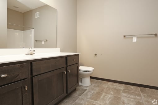 an empty bathroom with a toilet and a sink