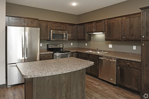 a kitchen with stainless steel appliances and granite counter tops