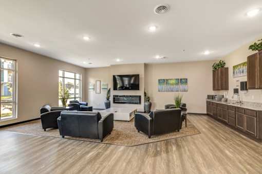A spacious living room with a television, couches, and a rug.