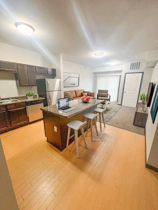 A kitchen with a table and chairs in the middle of the room.